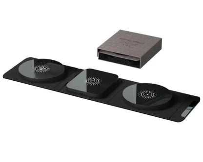 Black electronic device with three circular components and a box on a white background